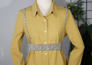 Detailed macro view of luxurious silver rhinestone body chain layered over a shirt