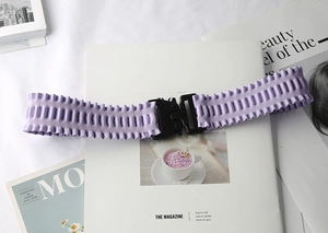 Detail of purple elastic belt featuring a black matte tactical buckle and wavy texture
