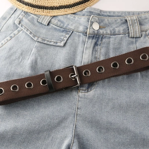 Brauner Leinwand-Ösengürtel mit Silberschnalle kombiniert mit hellblauer Washed-Jeans