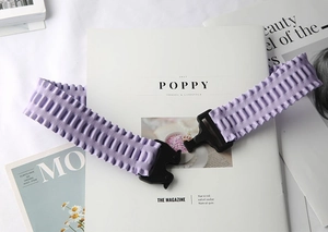 Detail of lavender elastic waist belt with textured pleats and black plastic buckle clasp