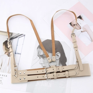 Fashionable beige faux leather body harness with dual buckles and silver rings on magazines