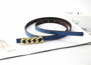 Detail of blue Saffiano leather belt with gold chain-link buckle and white stitching