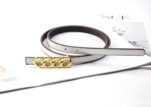 Detail of white cross-grain leather belt with a golden chain buckle for dresses