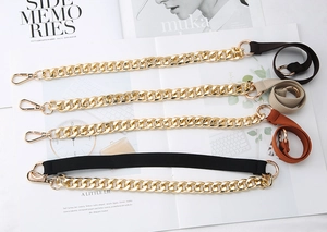 Detail of four colorful bag straps with gold metal chunky chains and lobster clasps