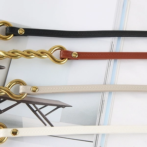 Close-up of leather straps in multiple colors featuring gold rings and zigzag stitching