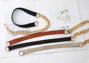 Detail view of multi-color elastic straps with luxury gold metal rings and chains