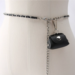 Detail of silver metal chain belt with black leather weave and mini textured pouch