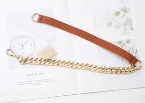 Detail view of brown elastic strap with gold chunky chain and lobster clasp