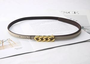 Close-up of slim beige Saffiano leather belt with golden four-link chain buckle