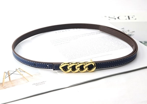 Detail of slim blue leather belt with golden chain buckle and white contrast stitching