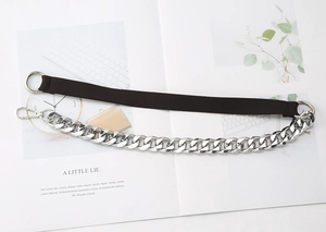 Detail of detachable shoulder strap with brown woven webbing and chunky silver metal chain