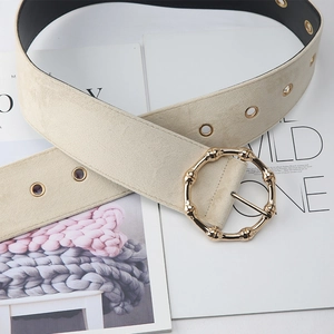 Macro view of oatmeal beige suede waist belt with golden bamboo metal buckle and eyelets