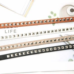 Vintage skinny belts with metallic square studs in brown, white, khaki, and black leather