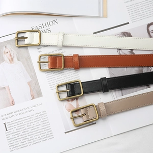 Set of four vintage PU leather belts in black, brown, white, and beige with gold buckles
