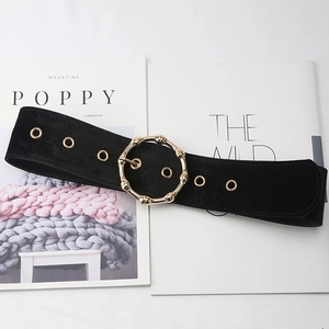 Women's black velvet waist belt featuring a vintage gold bamboo buckle and metal eyelets