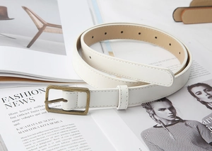 Detailed view of cream PU leather belt featuring a vintage bronze buckle and fine stitching