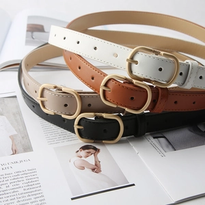 Detail view of four vintage leather belts with oval gold buckles in multiple colors
