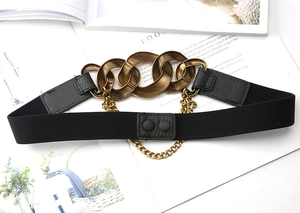 Detailed close-up of a black elastic waist belt with gold chain decoration and snap buttons