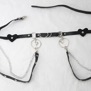 Detail of punk gothic waist belt with leather heart pendant and metal chains