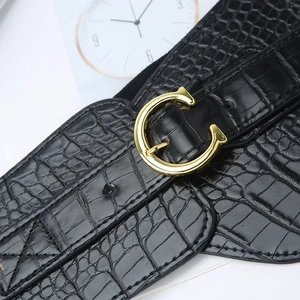 Women's black elastic wide belt with crocodile embossing and gold C-buckle closure