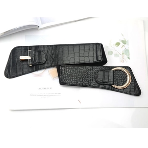 Women's wide black elastic waist belt with gold round buckle and crocodile texture