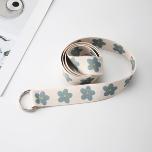 Floral print canvas belt with silver double D-ring buckle on a clean white background