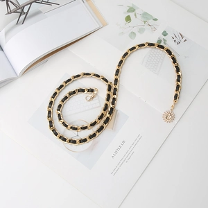 Retro gold metal chain belt with black leather weave and elegant sun pendant accessory