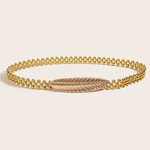 Detailed view of golden elastic beaded waist chain with elegant feather-shaped buckle