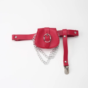 Detail of red punk thigh garter belt with silver chains and adjustable metal buckles