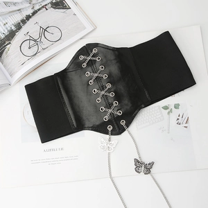 Detail of black corset belt featuring silver crisscross chains and butterfly charms
