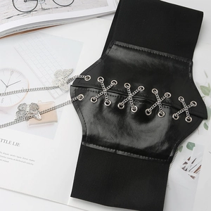Detail of black wide elastic corset belt featuring metal eyelets and butterfly charms