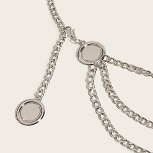 Detail view of silver layered metal chain belt with polished circular medallion charms