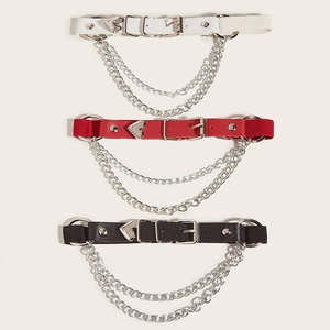 Detail of punk leather leg garters with metal heart accents and chains in three colors