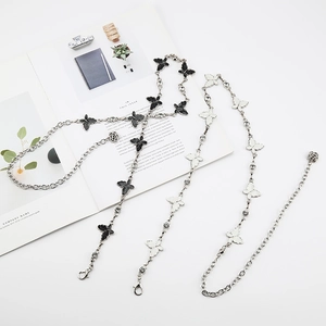 Detailed macro of silver butterfly waist chain with sparkling inlay and rose pendant