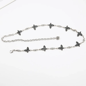Detail of silver butterfly waist chain with black glitter accents and sparkling rhinestones