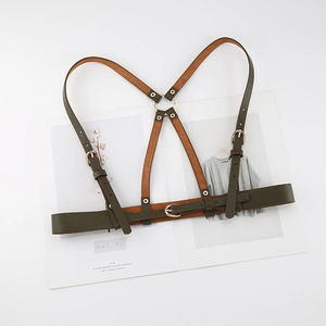 Adjustable olive green punk body harness with gold metal rings and rivets on white background