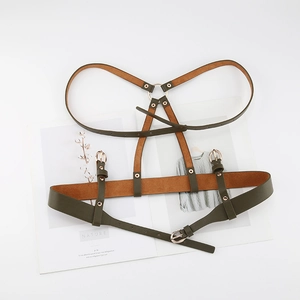 Detail showing army green leather harness with gold metal rings and adjustable straps
