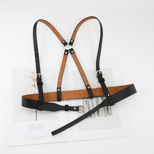 Detail of black PU leather body harness with Y-shaped back and golden buckles