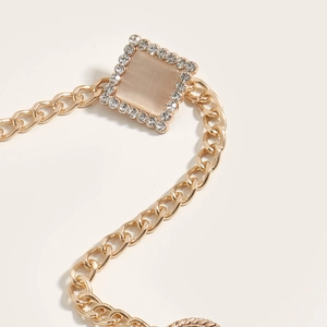 Golden metal waist chain featuring a square pink cat eye stone buckle with rhinestones
