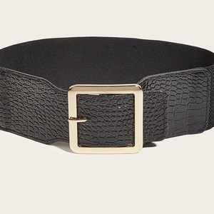 Detail of black elastic corset belt with gold square buckle and faux crocodile texture