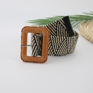Detail of black and white V-weave woven belt with textured brown rectangular buckle