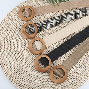 Detailed macro view of woven elastic belts in five colors with round wooden buckles