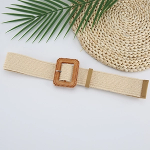 Detail of bohemian beige woven elastic belt featuring a rectangle faux rattan buckle
