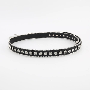 Close-up of black leather belt with sparkling rhinestones and silver beaded metal trim