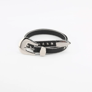 Detail of black western belt with silver star studs and decorative beaded edges