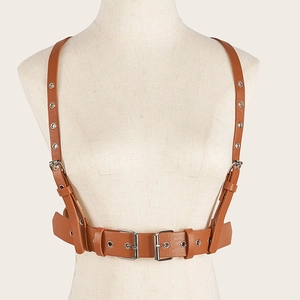 Detail of punk style brown PU leather corset belt with silver metal eyelets on a mannequin
