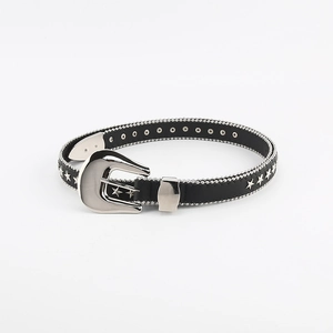 Detail of western style floral carved silver buckle and star studs on thin black belt