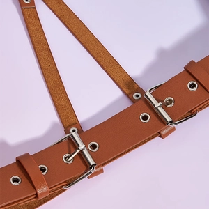 Detailed close-up of brown litchi pattern leather straps and silver metal buckles