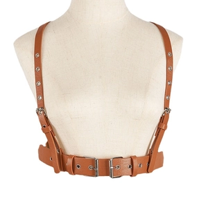 Brown faux leather harness belt with silver eyelets and adjustable buckles on white mannequin