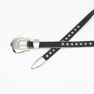 Detail of a thin black leather belt featuring silver star rivets and a metallic western buckle